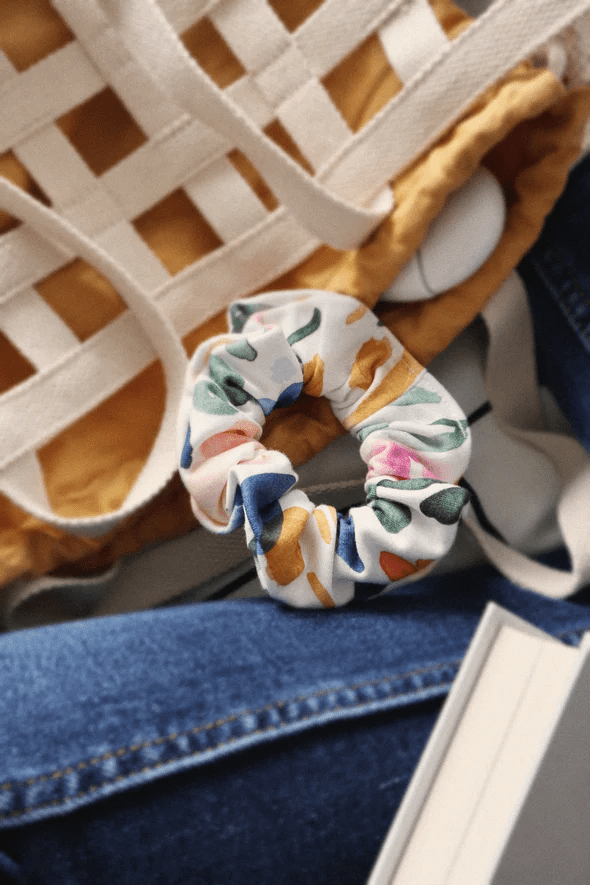 Scrunchie in Sierra Florals, a colourful floral print, together with a tote back and book